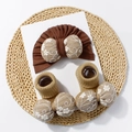 Détail d'un ensemble turban et chaussettes bébé avec nœuds brodés sur fond tissé - Ensemble Bonnet et Chaussettes / Marron
