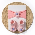 Pink knit baby headband and socks set with 3D floral accents on white display card - Pink