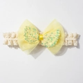 Detail of baby lace headband featuring a yellow double mesh bow with colorful sequins - Yellow