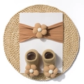 Detailed knit texture of baby headband and socks set with 3D fabric flower accents - Brown
