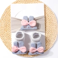 Detailed view of grey knitted baby headband and socks set with cute bunny ears and bows - 2-Piece Set (1 Headband + 1 Pair of Socks) / Gray