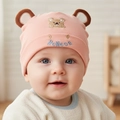 Close-up of pink cotton infant beanie featuring 3D bear ears and animal embroidery - Orange