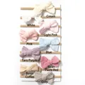 Vertical display of multi-colored nylon baby headbands with soft fabric bow details - 9 Colors Mixed