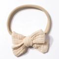 Detail of soft cream nylon baby headband with textured double-layer cotton bow - Beige Coffee