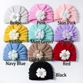 Flat lay of baby turban hats in ten different colors with knit flower details - 10 Colors Mixed