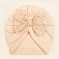 Detail of baby turban hat with large light peach mesh bow and golden sequin dots - Nude Pink