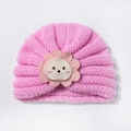 Detail of baby knit hat showing pink woolen texture and cute animal sunflower patch - Pink