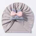 Detailed view of baby turban hat with cute grey plush bunny and pink bow decoration - Gray