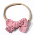 Detail of baby headband featuring soft pink muslin cotton bow and elastic strap - Dusty Pink