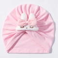 Detail of pink baby turban hat with white rabbit ears and soft knit texture finish - Pink