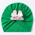 Detail of green knit baby turban hat with a cute pink plush bunny and bow decoration - Green