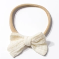 Detail of soft cream cotton gauze bow on elastic nylon headband for infants and babies - Beige
