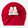 Detail of red newborn turban hat featuring a plush white bunny head with pink bow - Red