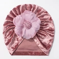 Detail of baby turban hat featuring pink golden velvet fabric and a large layered cloth flower - Dust Rose