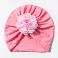 Detail of bright pink knitted baby turban hat with a large chiffon flower and herringbone texture - Pink