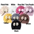 Detailed view of infant turban hats in eight colors with large lace bow decorations - Multicolor