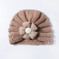 Detailed knit texture of a pink baby turban hat with a 3D floral accent and button - Light Coffee