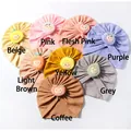 Flat lay of eight colorful waffle knit baby turban hats with cute cartoon fruit patches - 8-Color Mix