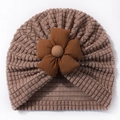 Detailed macro of coffee brown waffle knit baby beanie featuring a 3D floral decoration - Coffee