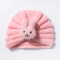 Detail of pink knitted baby hat featuring a soft plush rabbit decoration for infants - Snow Bud