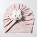 Close-up of pink baby turban hat featuring a cute white plush bunny patch detail - Lotus Pink