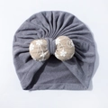 Close-up of grey baby turban hat with beige stuffed bow and white floral embroidery - Gray