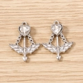 Macro detail of silver Cupid arrow pendants with heart-shaped crystal on wood surface - 5 Pieces / Silver