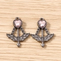 Macro shot of gun-black heart arrow pendants with pink gemstone on wood surface - 5 Pieces / Black Purple