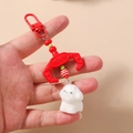 Detail of red claw machine hook keychain with fluffy white plush puppy dog and beads - Red Dog