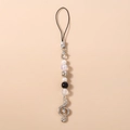 Detail of beaded phone strap with pearl beads and rhinestone treble clef music pendant - Black