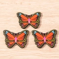 Detailed view of colorful butterfly-shaped resin charms with holes for DIY jewelry making - 10 Pieces Pack / Orange