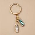 Portachiavi dorato alla moda con pendenti quadrati in strass e cristalli verde smeraldo - Gemme Geometriche