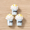 Macro shot of resin popcorn bucket charms with blue stripes and silver metal rings - 5 Pieces / Blue