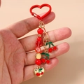 Detail of beaded cherry keychain featuring red heart beads and enamel fruit charms - Heart Cherry Beaded
