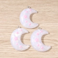 Macro shot of crescent moon charms with pink stars and silver rings on wood surface - 10 Pieces Pack / White