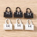 Detailed view of mini resin handbag charms with quilted texture and bow accents - 5 Pieces / Multicolor