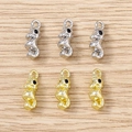Macro shot of gold and silver seahorse charms for DIY jewelry on a wooden background - Mixed Sea Horse