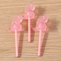 Close-up of three pink resin dinosaur lollipop charms with glitter and silver metal rings - 10 Pieces Pack / Pink