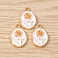 Detailed macro of golden rose oval charms with white enamel and LOVE engraving - 10 Pieces Pack / White