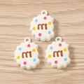Macro detail of biscuit-shaped resin charms with letter M and colorful dots for DIY crafts - 10 Pieces Pack / White