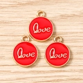 Macro view of three red enamel round Love charms with gold metal edges and hanging loops - LOVE Letter Round Tag (3206) / 10 Pieces Pack / Red