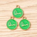 Detailed macro view of green enamel Love charms with gold metal edges and hanging loops - LOVE Letter Round Tag (3206) / 10 Pieces Pack / Green