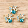 Détails de trois breloques papillon et fleur en cristal bleu pour création de bijoux DIY - Papillon de Fleur / Lot de 10 / Or Bleu
