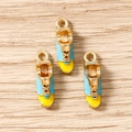 Detailed view of light blue and yellow enamel sneaker charms for DIY jewelry making - Sneaker Style / 10 Pieces Pack / Sky Blue/Yellow/Gold