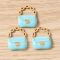 Detailed macro view of light blue enamel handbag charms with gold metal chain for DIY jewelry - 10 Pieces Pack / Lake Blue
