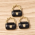 Macro detail of three black enamel handbag charms with golden handles for DIY jewelry - 10 Pieces Pack / Black