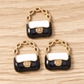 Macro view of three mini handbag pendants with black and white enamel on wood surface - 10 Pieces Pack / Black & White