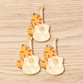Detail of three sunflower guitar enamel charms with musical notes on wood background - 10 Pieces Pack / Orange Floral Guitar
