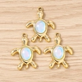 Detailed top view of three turtle charms with iridescent opal inlay on gold metal base - 10 Pieces Pack / Gold Blue