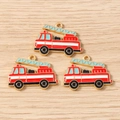 Detailed close-up of red enamel fire truck charms for DIY jewelry and keychain making - Fire Truck